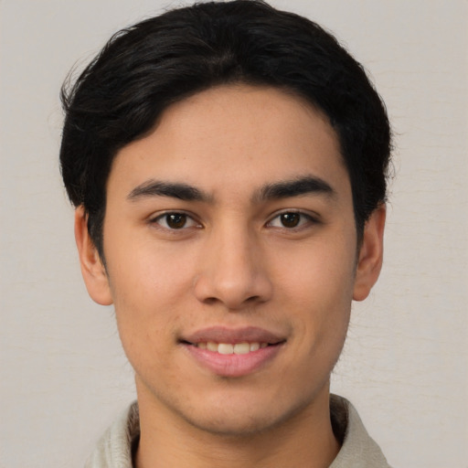 Joyful asian young-adult male with short  black hair and brown eyes