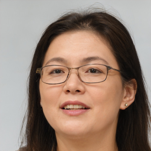 Joyful white adult female with long  brown hair and brown eyes