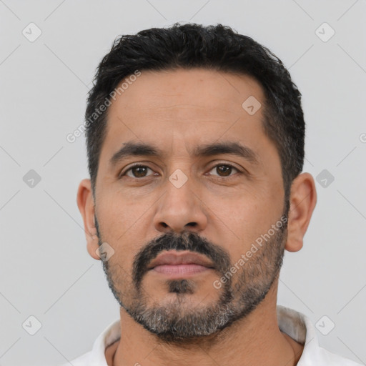 Neutral latino adult male with short  black hair and brown eyes