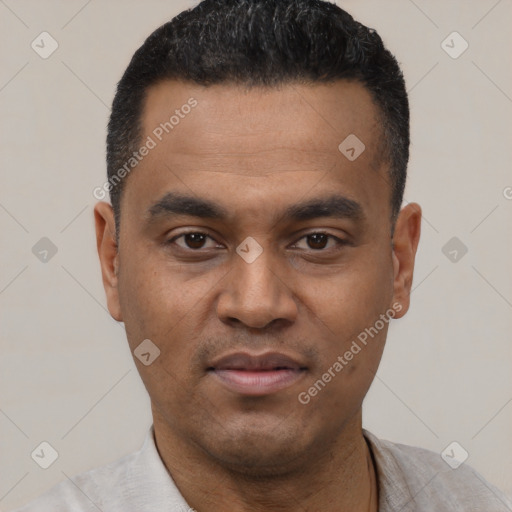 Joyful latino young-adult male with short  black hair and brown eyes