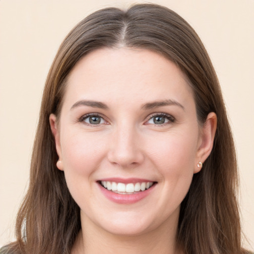 Joyful white young-adult female with long  brown hair and grey eyes