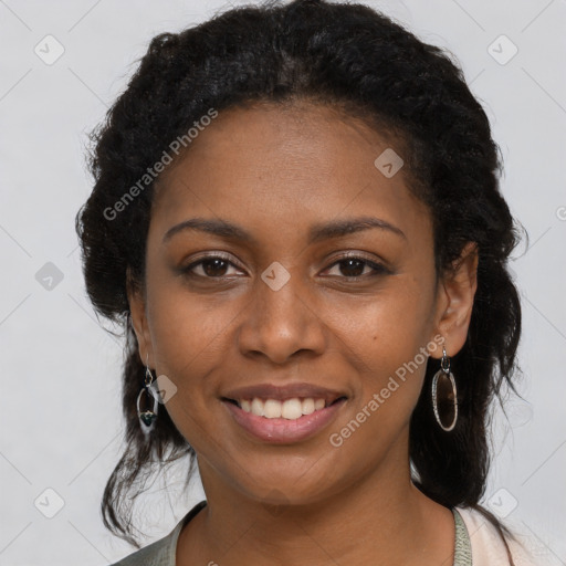 Joyful black young-adult female with long  black hair and brown eyes