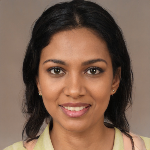 Joyful black young-adult female with medium  brown hair and brown eyes