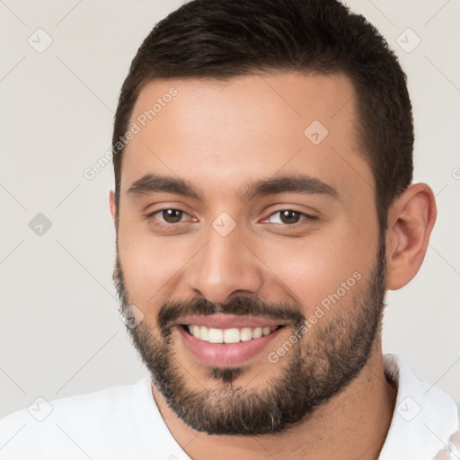 Joyful white young-adult male with short  brown hair and brown eyes