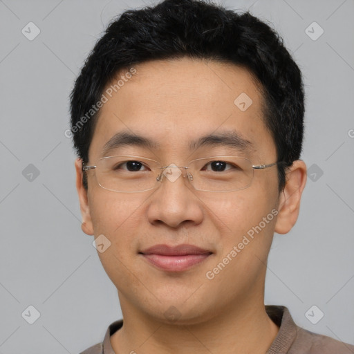 Joyful asian adult male with short  black hair and brown eyes