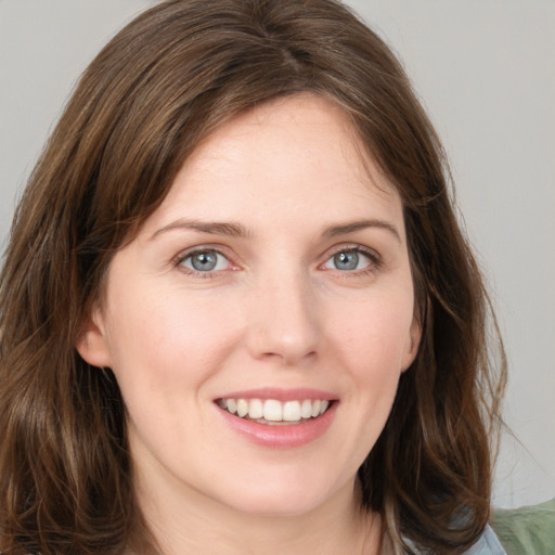 Joyful white young-adult female with medium  brown hair and green eyes