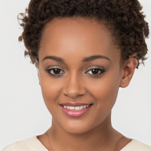 Joyful black young-adult female with short  brown hair and brown eyes