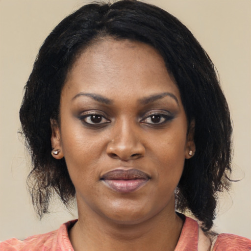 Joyful black young-adult female with medium  black hair and brown eyes