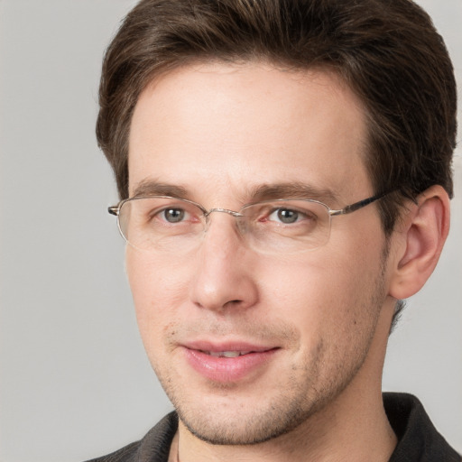 Joyful white adult male with short  brown hair and grey eyes