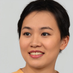 Joyful asian young-adult female with short  black hair and brown eyes