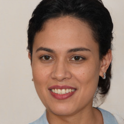 Joyful latino young-adult female with short  brown hair and brown eyes