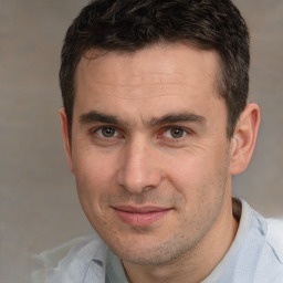 Joyful white young-adult male with short  brown hair and brown eyes