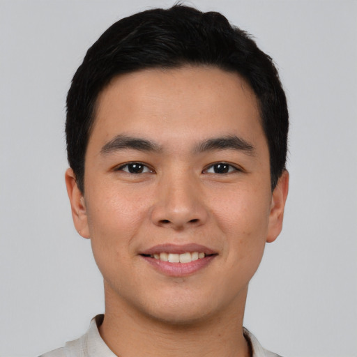 Joyful asian young-adult male with short  black hair and brown eyes