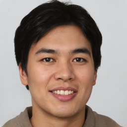 Joyful asian young-adult male with short  black hair and brown eyes