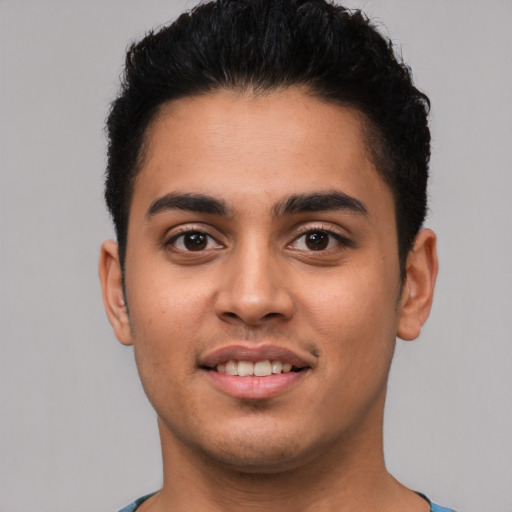 Joyful latino young-adult male with short  brown hair and brown eyes