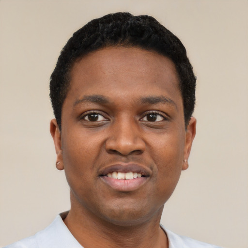 Joyful black young-adult male with short  black hair and brown eyes