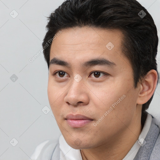 Joyful white young-adult male with short  black hair and brown eyes