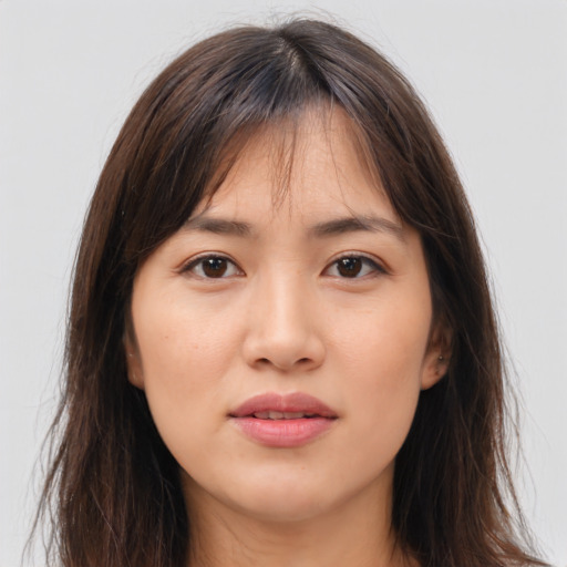 Joyful asian young-adult female with long  brown hair and brown eyes