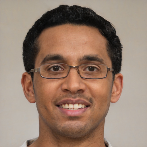 Joyful white adult male with short  black hair and brown eyes