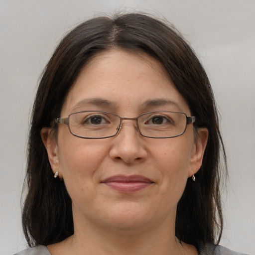 Joyful white adult female with medium  brown hair and grey eyes