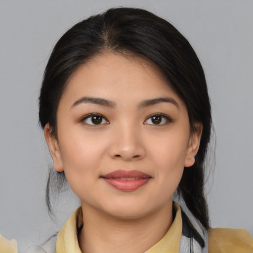Joyful asian young-adult female with medium  black hair and brown eyes
