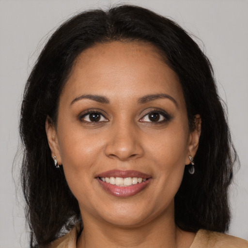 Joyful latino young-adult female with long  brown hair and brown eyes