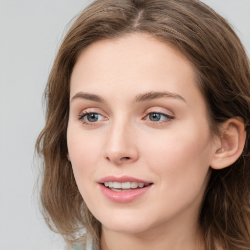 Joyful white young-adult female with long  brown hair and grey eyes