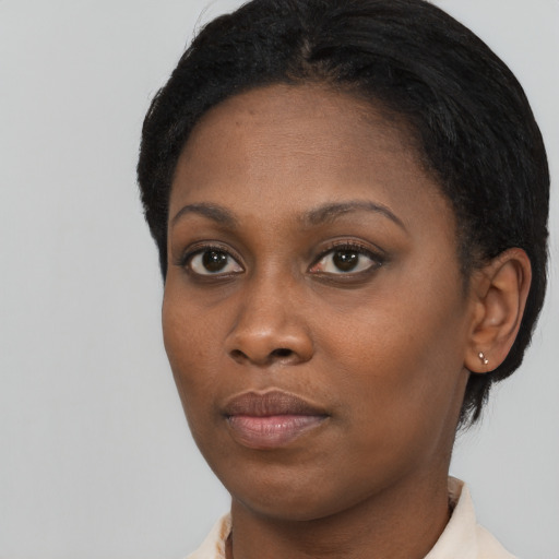 Neutral black young-adult female with short  black hair and brown eyes