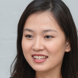 Joyful asian young-adult female with long  brown hair and brown eyes