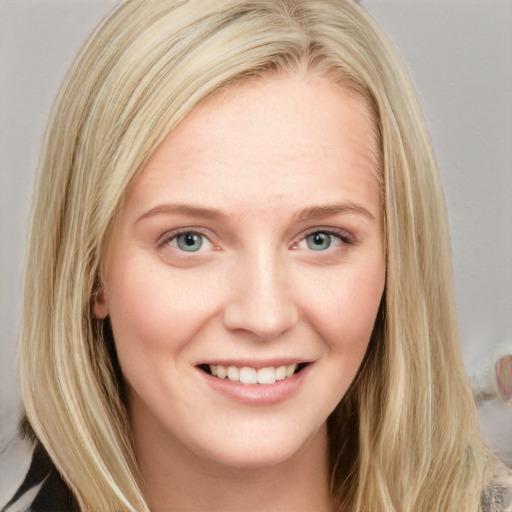 Joyful white young-adult female with long  blond hair and blue eyes