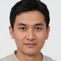 Joyful asian young-adult male with short  black hair and brown eyes