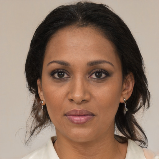 Joyful black young-adult female with medium  brown hair and brown eyes