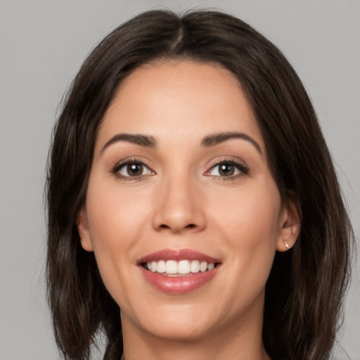 Joyful white young-adult female with medium  brown hair and brown eyes