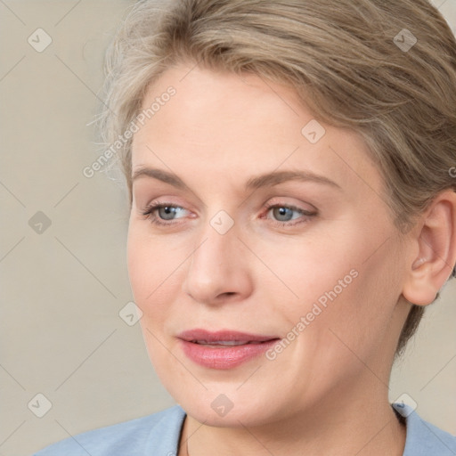 Joyful white adult female with medium  brown hair and blue eyes