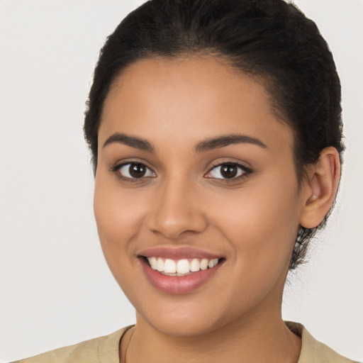 Joyful latino young-adult female with short  brown hair and brown eyes