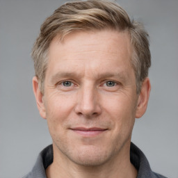 Joyful white adult male with short  brown hair and grey eyes