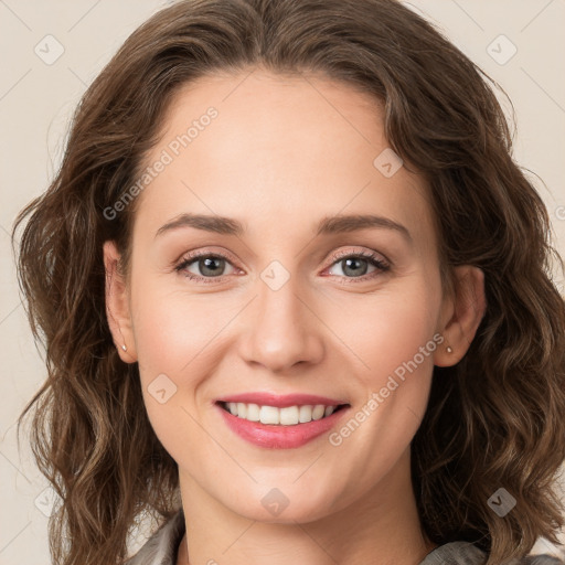 Joyful white young-adult female with long  brown hair and green eyes