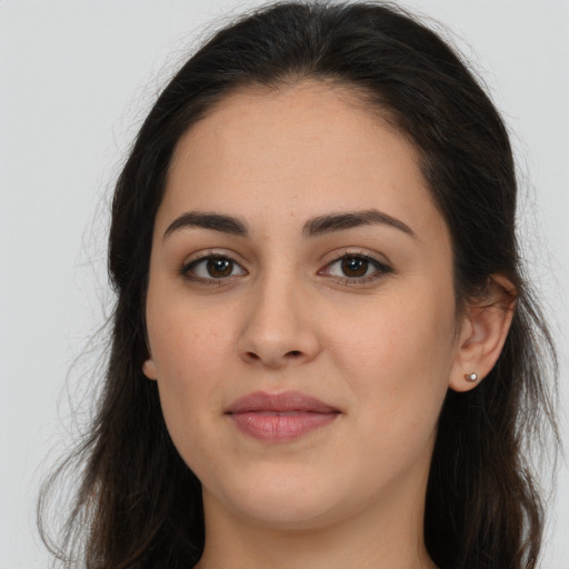 Joyful white young-adult female with long  brown hair and brown eyes