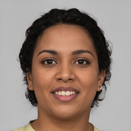 Joyful latino young-adult female with short  brown hair and brown eyes