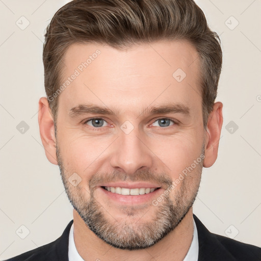 Joyful white adult male with short  brown hair and grey eyes