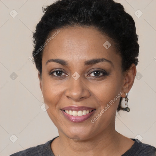 Joyful black young-adult female with short  black hair and brown eyes