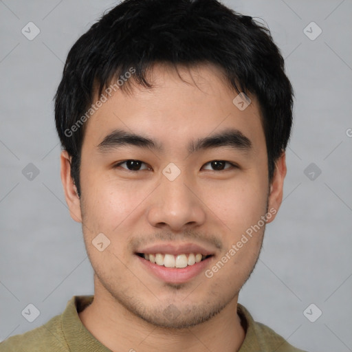 Joyful asian young-adult male with short  brown hair and brown eyes