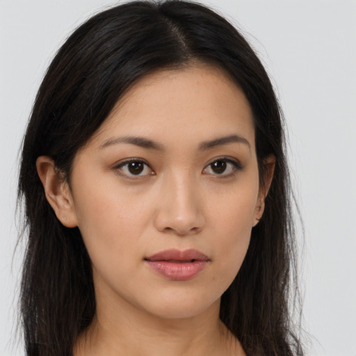 Joyful asian young-adult female with long  brown hair and brown eyes