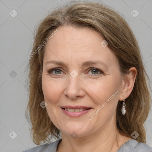 Joyful white adult female with medium  brown hair and grey eyes