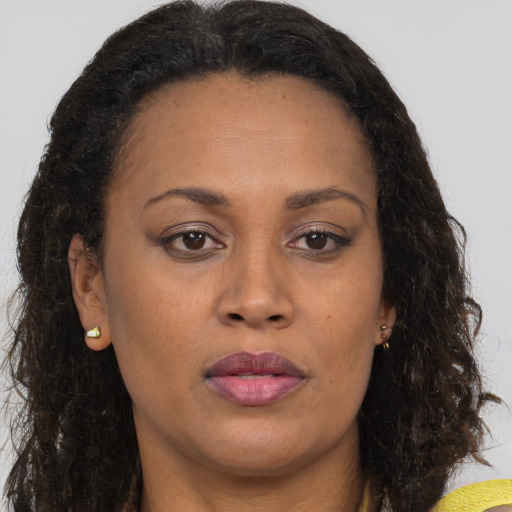 Neutral black adult female with long  brown hair and brown eyes