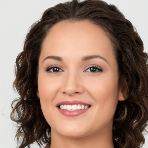 Joyful white young-adult female with long  brown hair and brown eyes