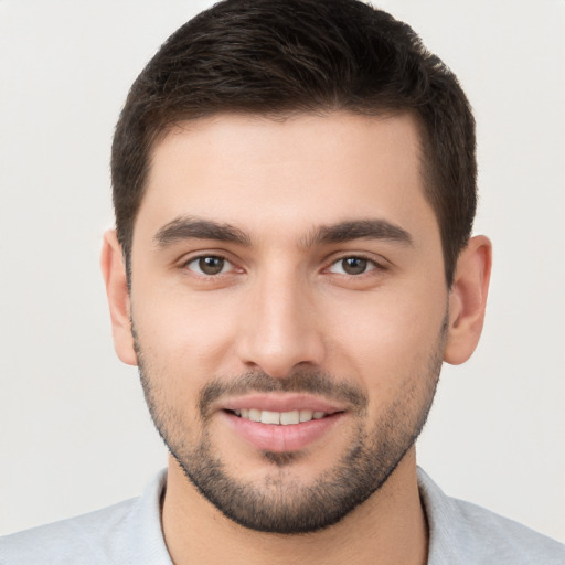 Joyful white young-adult male with short  brown hair and brown eyes