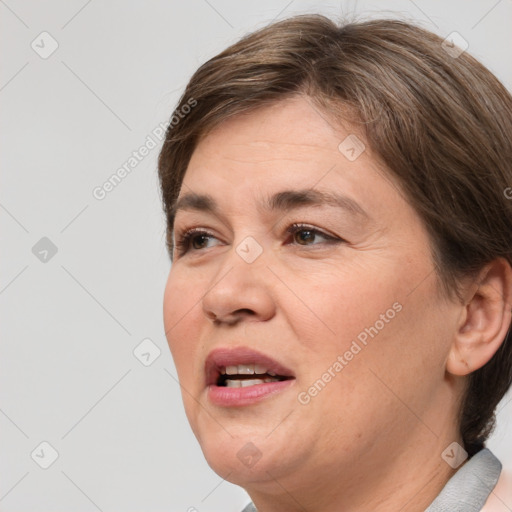 Joyful white adult female with medium  brown hair and brown eyes