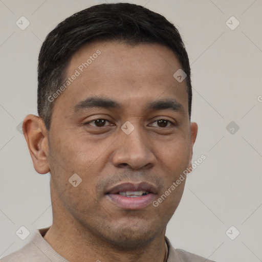 Joyful latino adult male with short  brown hair and brown eyes