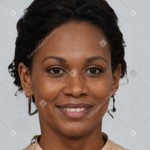 Joyful black adult female with short  brown hair and brown eyes